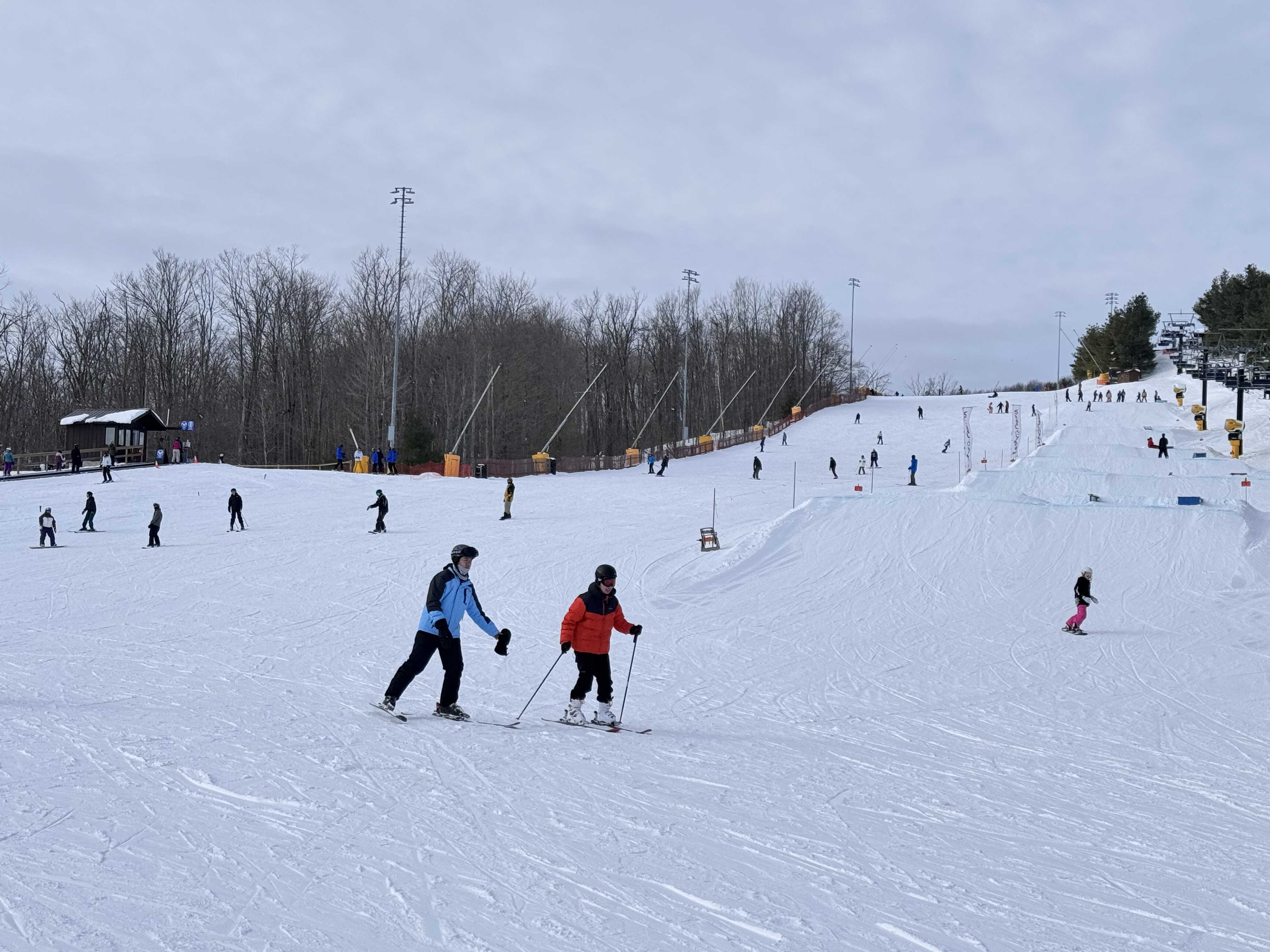 Instructor and student skiing together on the slope